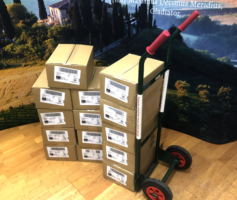 Stacked boxes of sales brochures with sack barrow